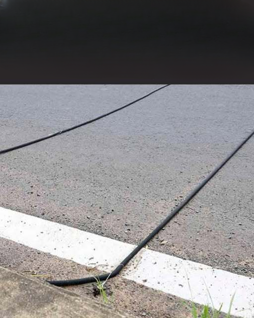Why You Sometimes See Black Cables Stretched Across the Road — And What They’re Actually Used For