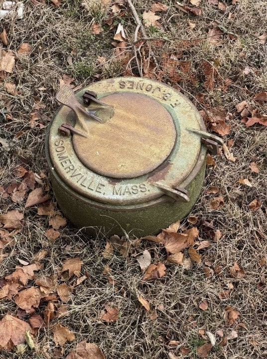 A Mysterious Metal Hatch Built Into the Ground Behind a House: What Could It Be?
